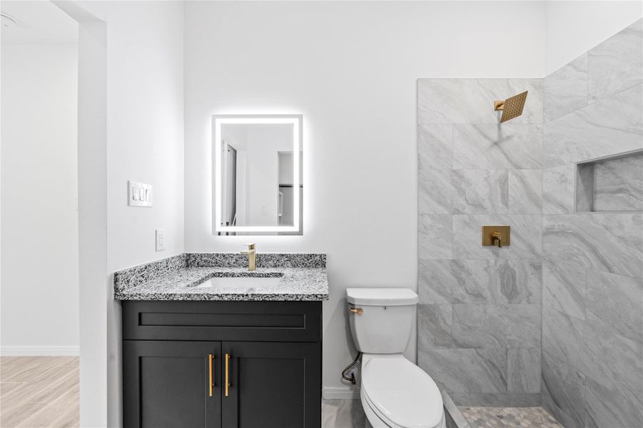 Tile Shower with Gold Knobs and Faucets