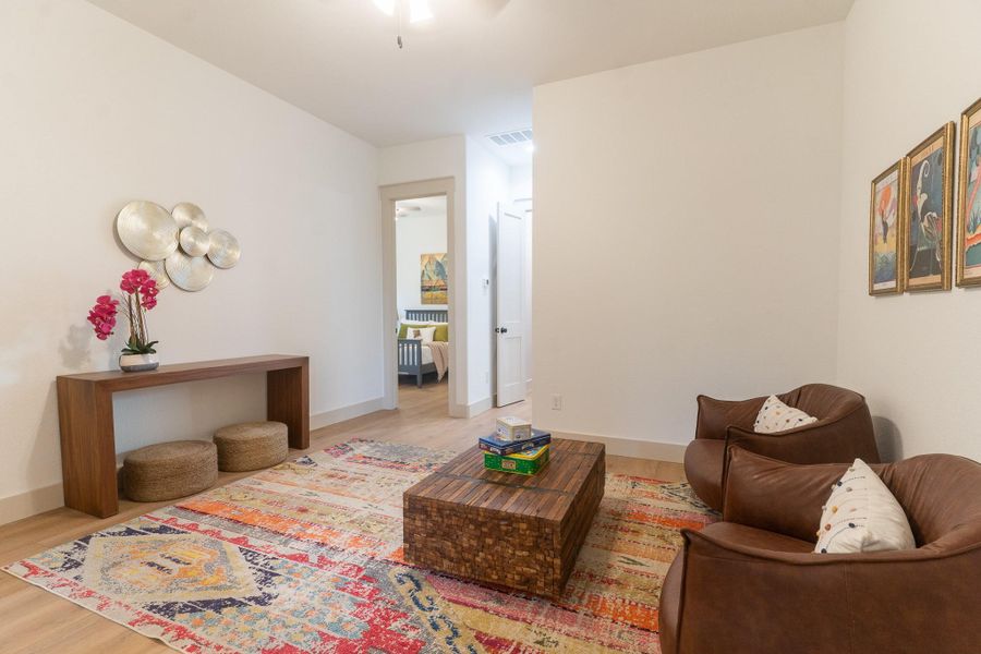 Living area with wood finished floors and a ceiling fan Living area with wood finished floors and a ceiling fan