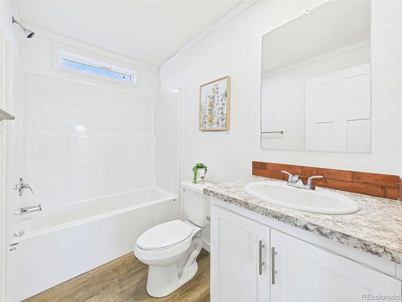 Crisp and clean with a full-size tub/shower combo, vanity with storage, and beautiful -style countertop.