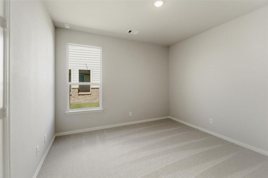 Unfurnished room featuring light carpet and baseboards
