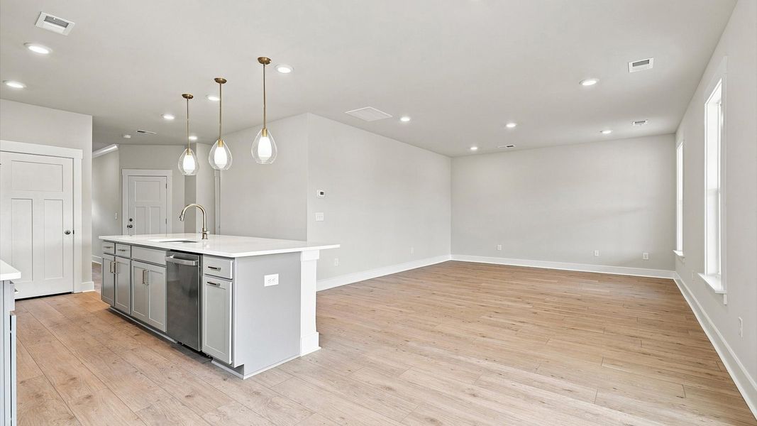 Exceptional culinary space with a striking 10-foot island and eye-catching pendant lights Exceptional culinary space with a striking 10-foot island and eye-catching pendant lights