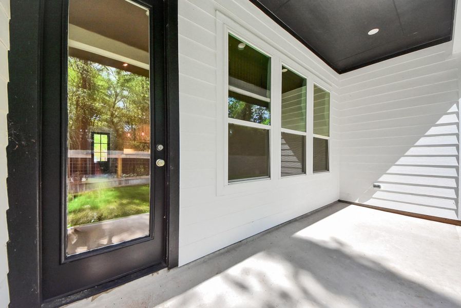 Welcoming covered patio to backyard. Perfect for relaxing and entertaining.