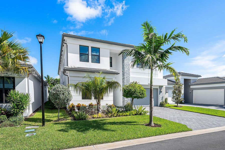 Front exterior of a new home in Lotus Edge, Boca Raton, FL, highlighting curb appeal (Image 30).