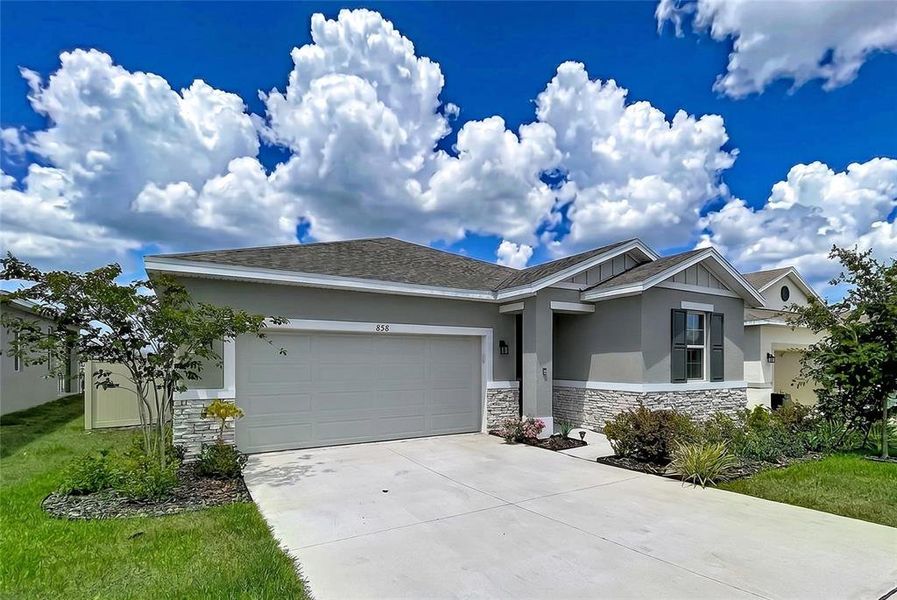 Front exterior of a new home in Seasons at Mabel Place, Lake Wales, FL, highlighting curb appeal (Image 31).