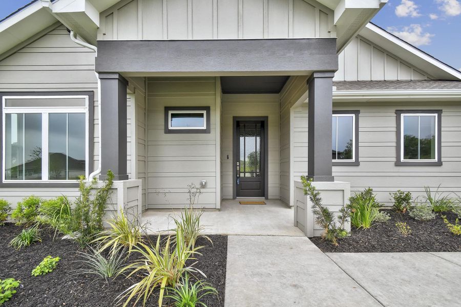 Front exterior of a new home in Double Eagle Ranch, Cedar Creek, TX, highlighting curb appeal (Image 2). Front exterior of a new home in Double Eagle Ranch, Cedar Creek, TX, highlighting curb appeal (Image 2).