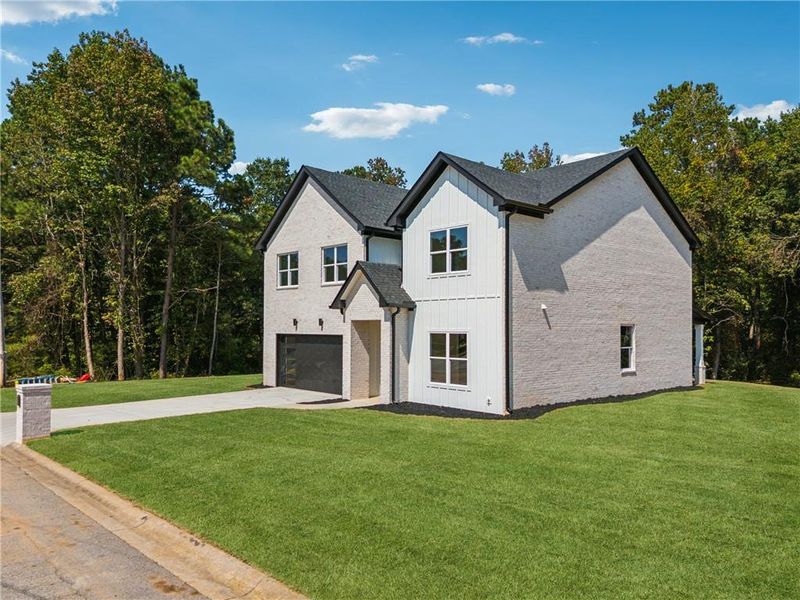 Front exterior of a new home in , Loganville, GA, highlighting curb appeal (Image 25).