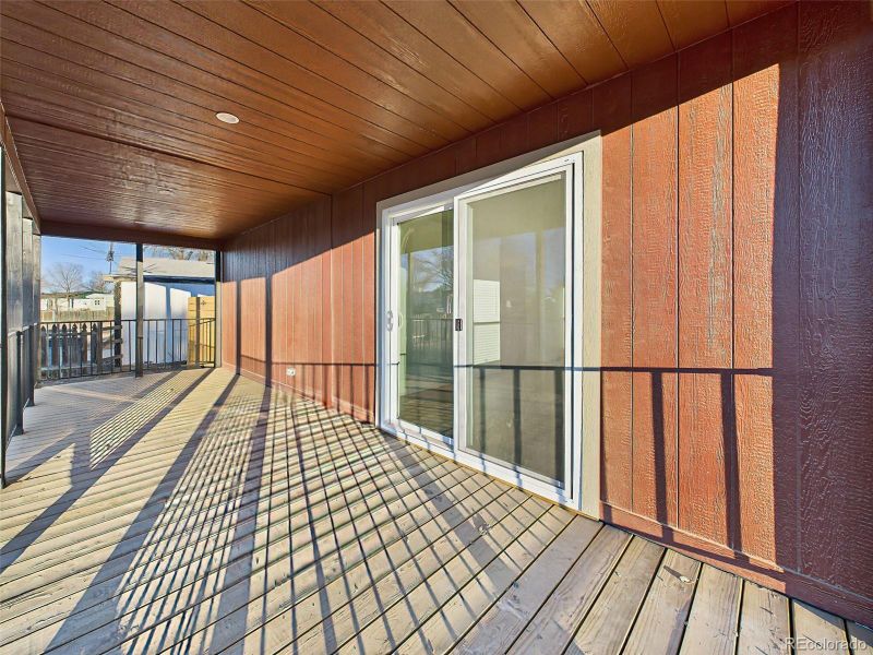 The covered deck provides a shaded, private space ideal for relaxing or entertaining.