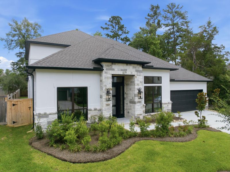 Front exterior of a new home in The Woodlands Hills 65′, Willis, TX, highlighting curb appeal (Image 2). Front exterior of a new home in The Woodlands Hills 65′, Willis, TX, highlighting curb appeal (Image 2).