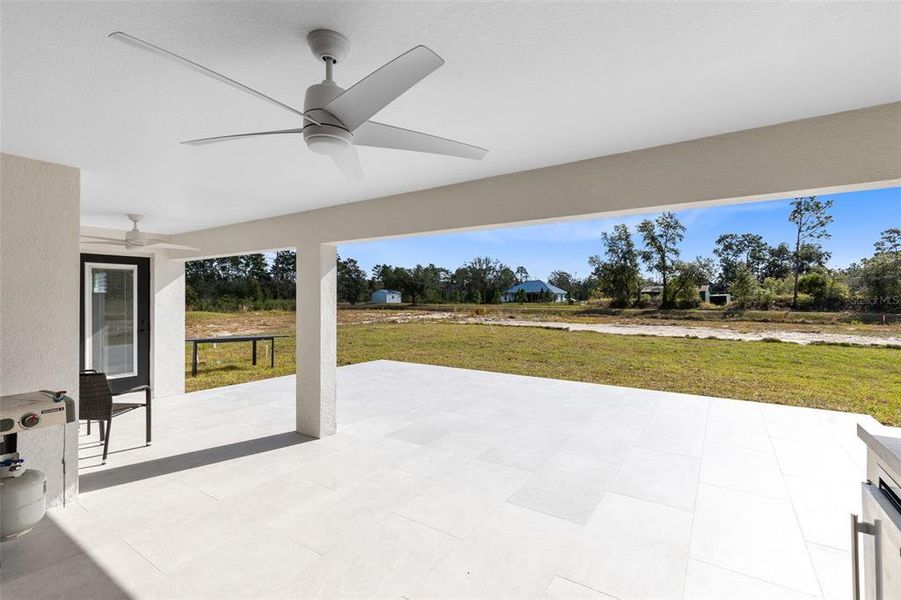 Step outside to enjoy the covered, tiled lanai that leads to an open, tiled patio, overlooking the tranquil canal view in your backyard.