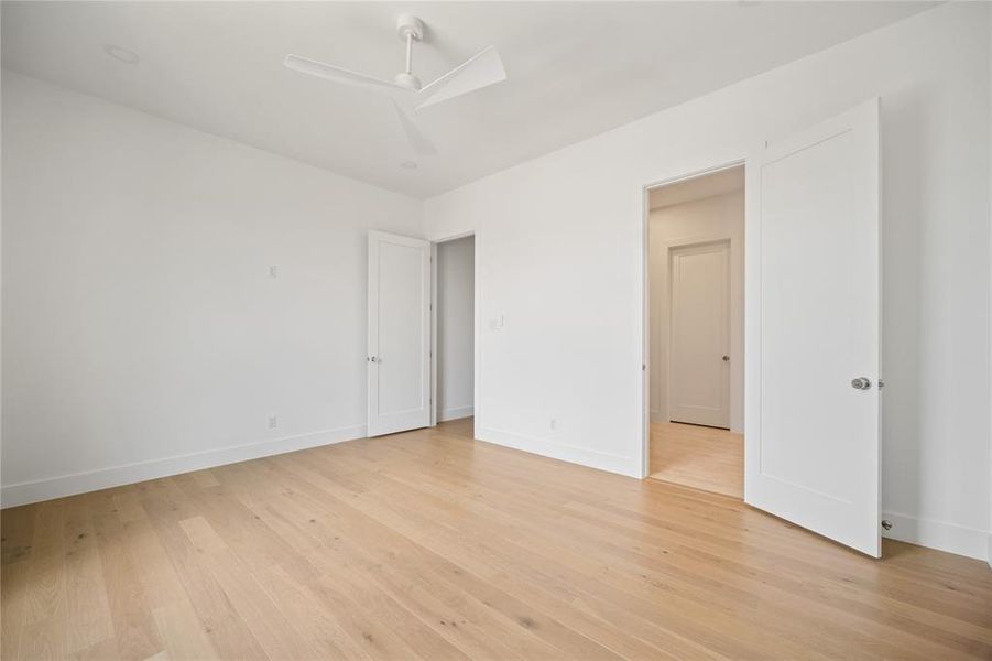 Unfurnished room with a ceiling fan and light wood-style flooring