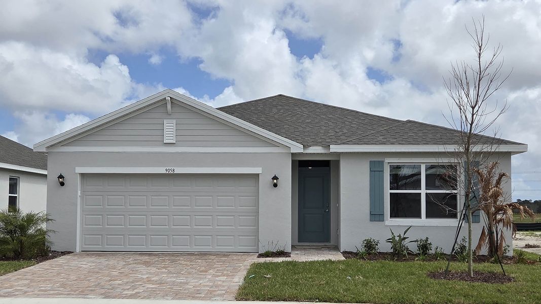 Front exterior of a new home in Venetian Grove, Vero Beach, FL, highlighting curb appeal (Image 1). Front exterior of a new home in Venetian Grove, Vero Beach, FL, highlighting curb appeal (Image 1).