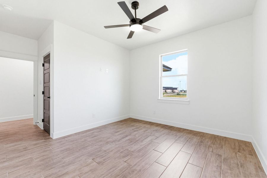 A well-lit room offers tiled flooring and a ceiling fan for comfortable living. A well-lit room offers tiled flooring and a ceiling fan for comfortable living.