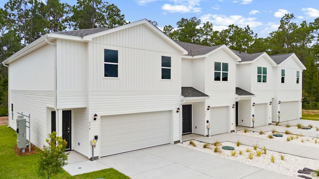 Front exterior of a new home in Chateau Nemours, Port Saint Joe, FL, highlighting curb appeal (Image 2). Front exterior of a new home in Chateau Nemours, Port Saint Joe, FL, highlighting curb appeal (Image 2).