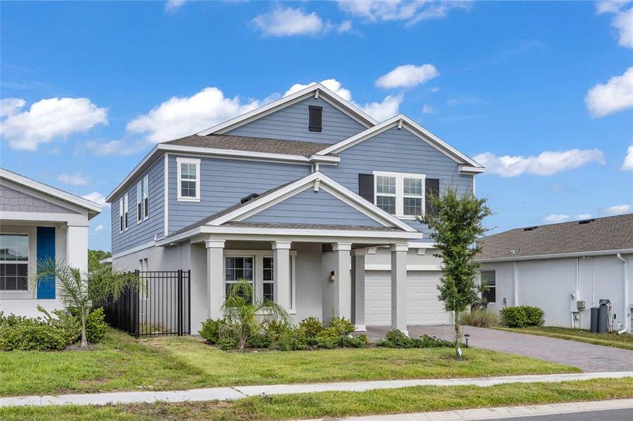 Front exterior of a new home in Providence, Davenport, FL, highlighting curb appeal (Image 21).