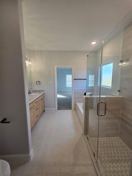 Bathroom featuring a garden tub, vanity, a stall shower, recessed lighting, and light tile patterned floors