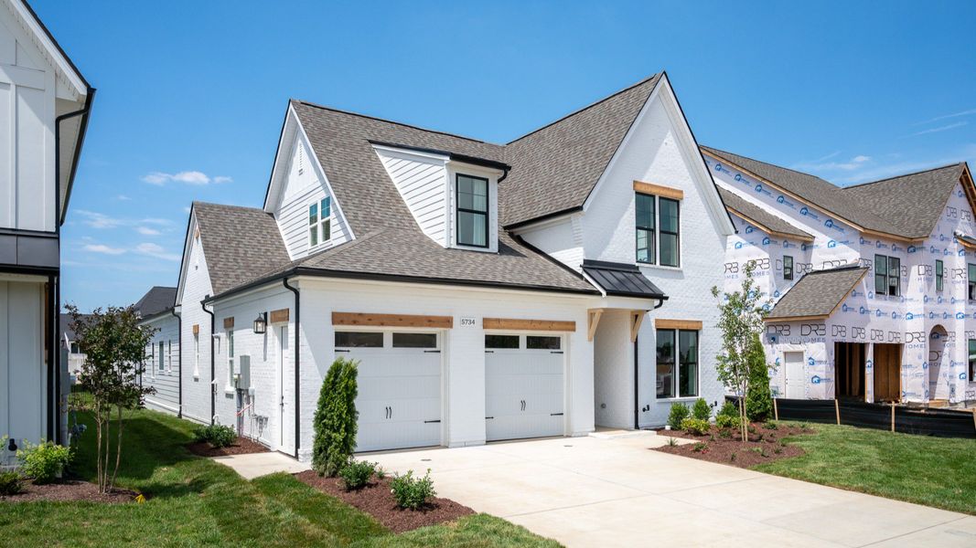 Front exterior with white siding and 2-car garage