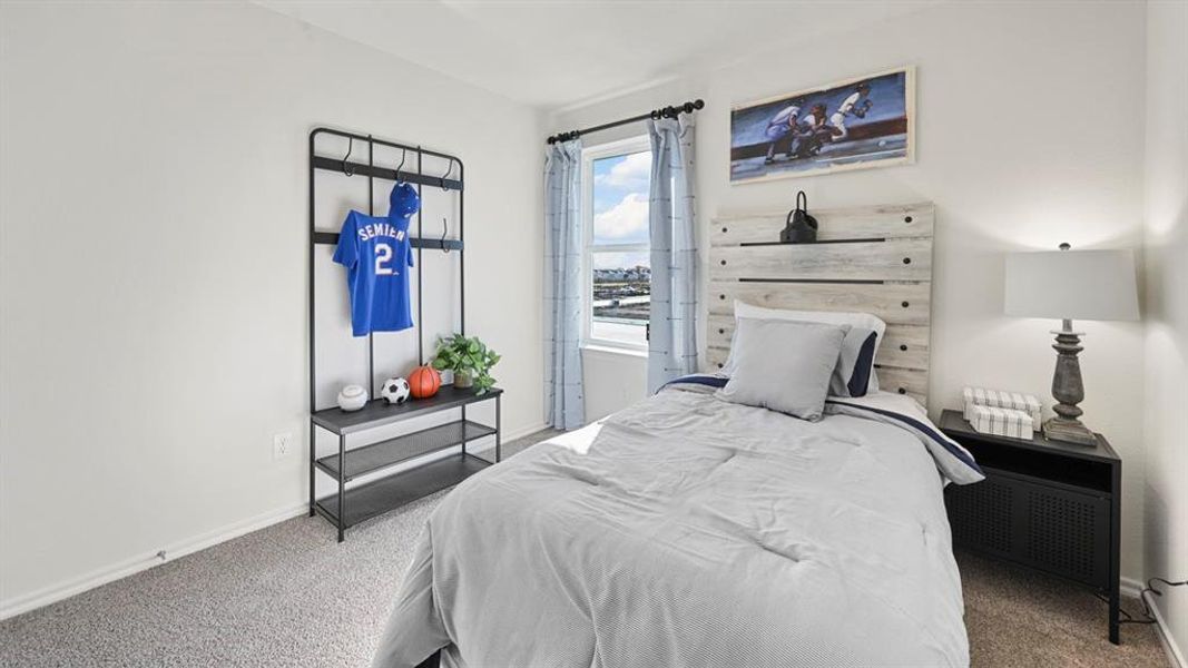 Carpeted bedroom with baseboards