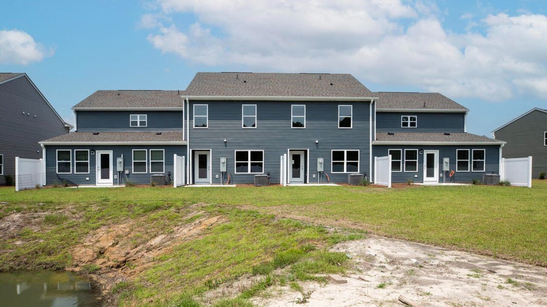 Exterior details and patio area of a home in Waterside Townhomes, Surf City (Image 2). Exterior details and patio area of a home in Waterside Townhomes, Surf City (Image 2).