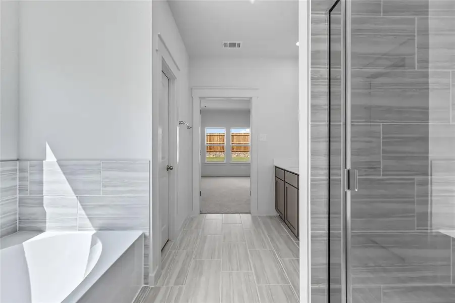 Bathroom featuring vanity, a bath, and a shower stall Bathroom featuring vanity, a bath, and a shower stall