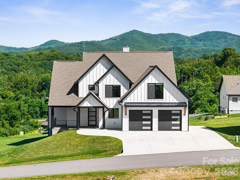 Front exterior of a new home in , Candler, NC, highlighting curb appeal (Image 32). Front exterior of a new home in , Candler, NC, highlighting curb appeal (Image 32).