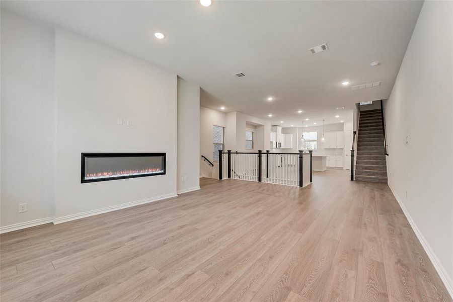 Unfurnished living room featuring light wood-type flooring