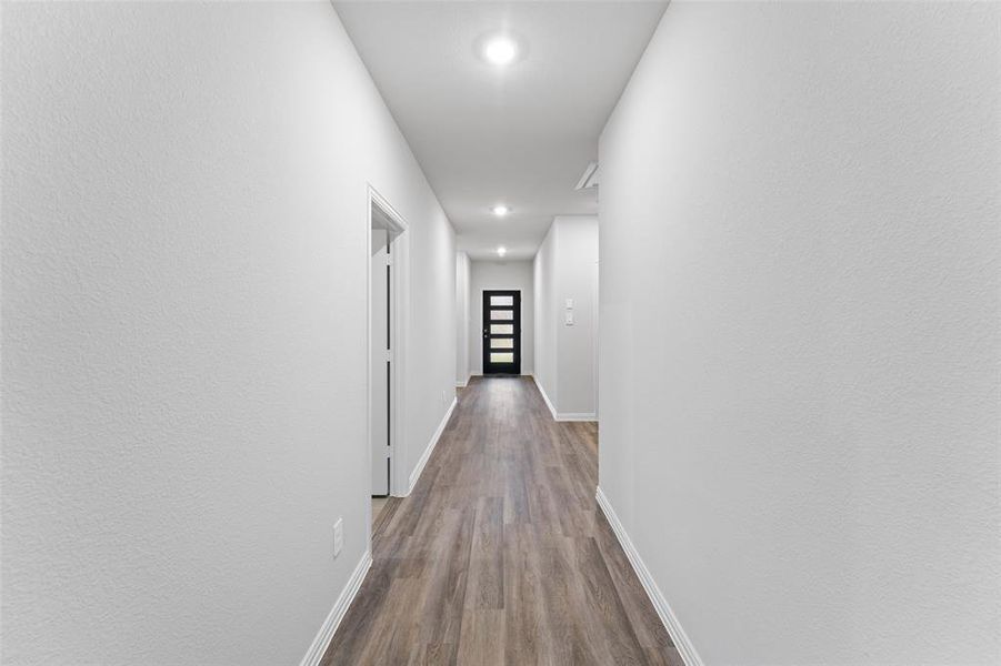 Hall featuring dark wood-style flooring and recessed lighting Hall featuring dark wood-style flooring and recessed lighting