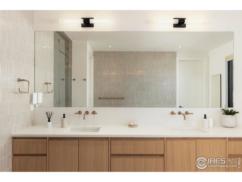 A spa-like ambiance includes a soaking tub, zero-entry rain shower, dual vanities, and a custom walk-in closet, all extending to a private patio overlooking uninterrupted western views. A spa-like ambiance includes a soaking tub, zero-entry rain shower, dual vanities, and a custom walk-in closet, all extending to a private patio overlooking uninterrupted western views.