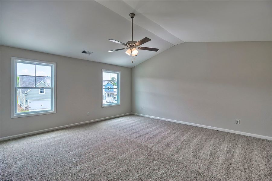 This spacious bedroom offers ample natural light a