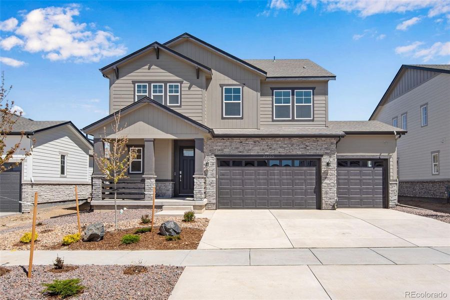 Front exterior of a new home in Prelude at The Aurora Highlands, Aurora, CO, highlighting curb appeal (Image 23).