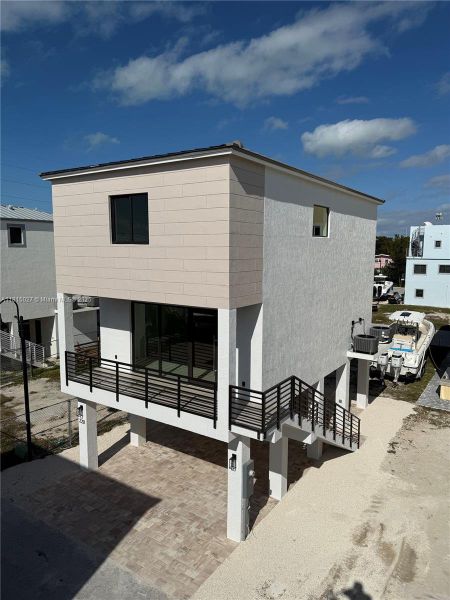 Front exterior of a new home in , Key Largo, FL, highlighting curb appeal (Image 10). Front exterior of a new home in , Key Largo, FL, highlighting curb appeal (Image 10).