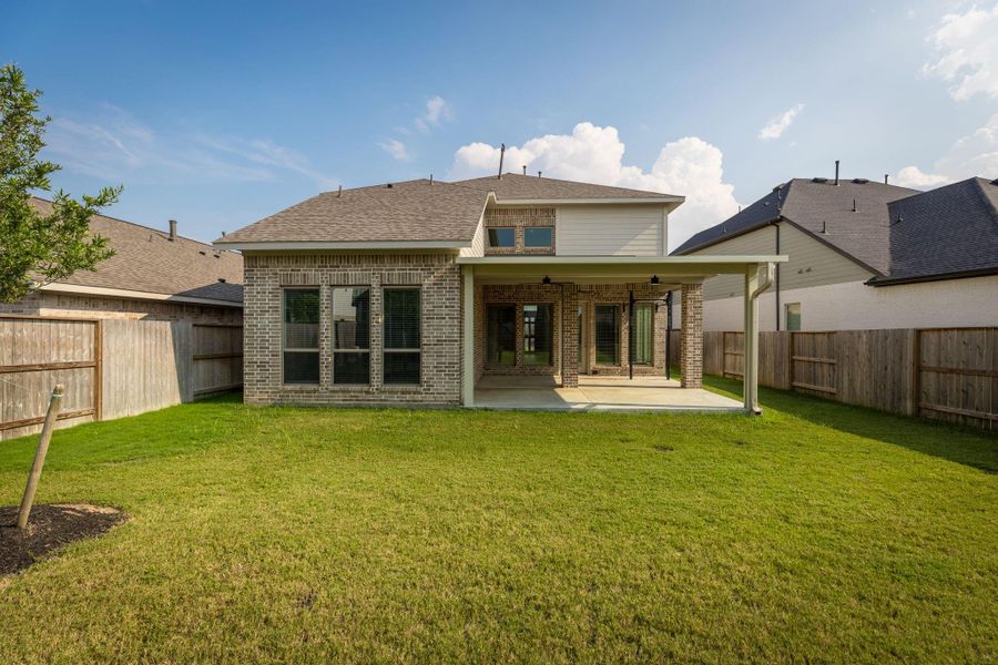 Front exterior of a new home in Cane Island 50', Katy, TX, highlighting curb appeal (Image 25). Front exterior of a new home in Cane Island 50', Katy, TX, highlighting curb appeal (Image 25).