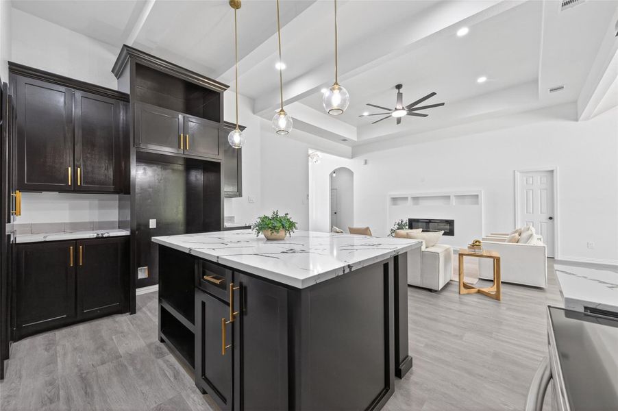 Stunning chef’s kitchen with oversized island, abundant custom cabinetry, modern finishes, and ample prep space for everyday living.