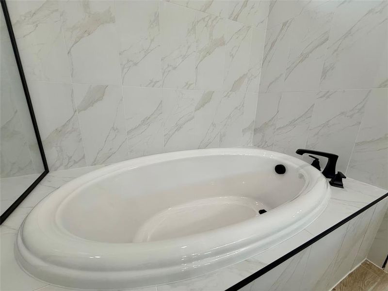 Full bathroom featuring a bath