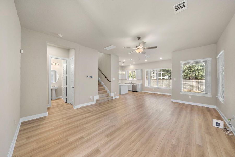 This bright and spacious living room features an open-concept design, seamlessly connecting to the dining and kitchen areas, perfect for entertaining.