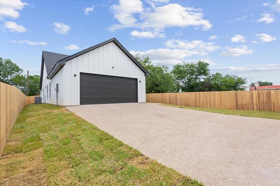 Garage featuring concrete driveway Garage featuring concrete driveway