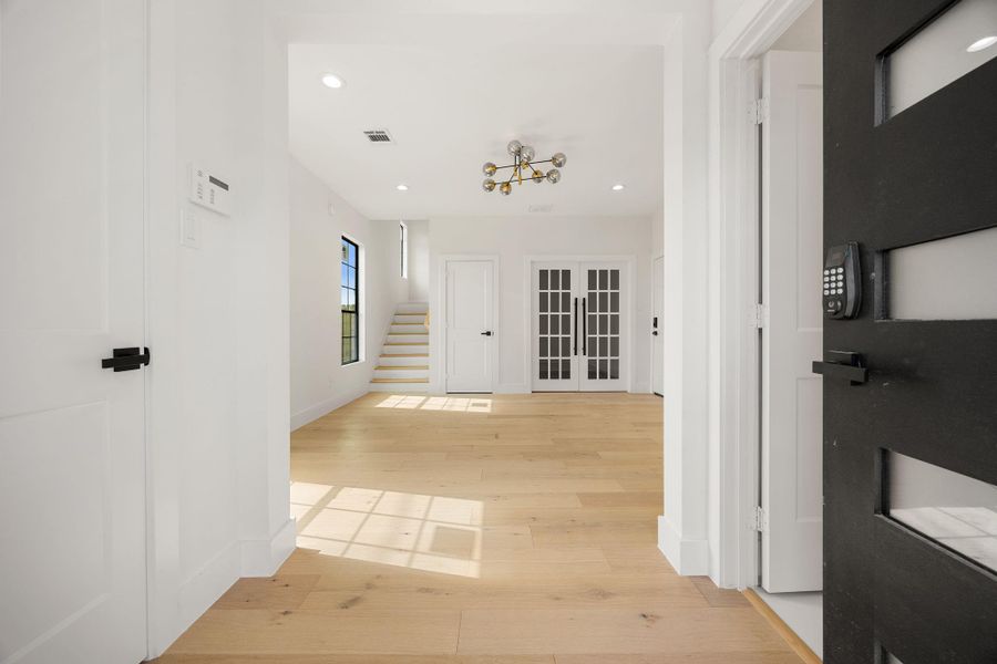 As you step inside, the spacious foyer offers access to a half bath, office, versatile flex space, garage, and a generous living area.