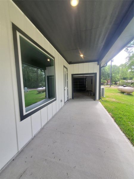 BACK PATIO WITH GOLF CART CUT-THROUGH TO THE GARAGE BACK PATIO WITH GOLF CART CUT-THROUGH TO THE GARAGE