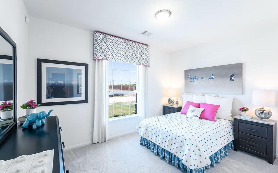 Secondary bedroom offering a bright and cheerful atmosphere with soft natural light, generous space for furnishings, and a welcoming feel that works beautifully for guests, family, or a home office setup. **Photos are representative only and may vary as built.**