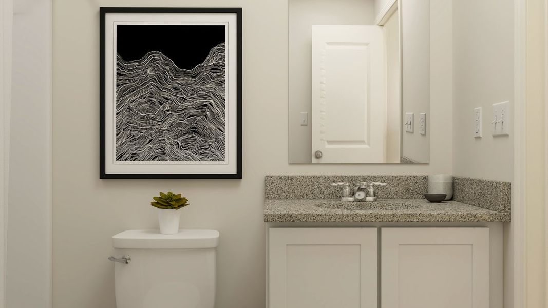 A bathroom with a picture on the wall. A bathroom with a picture on the wall.