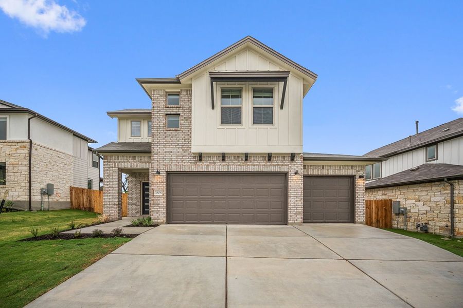 Front exterior of a new home in The Hills of Bear Creek, Manchaca, TX, highlighting curb appeal (Image 3).