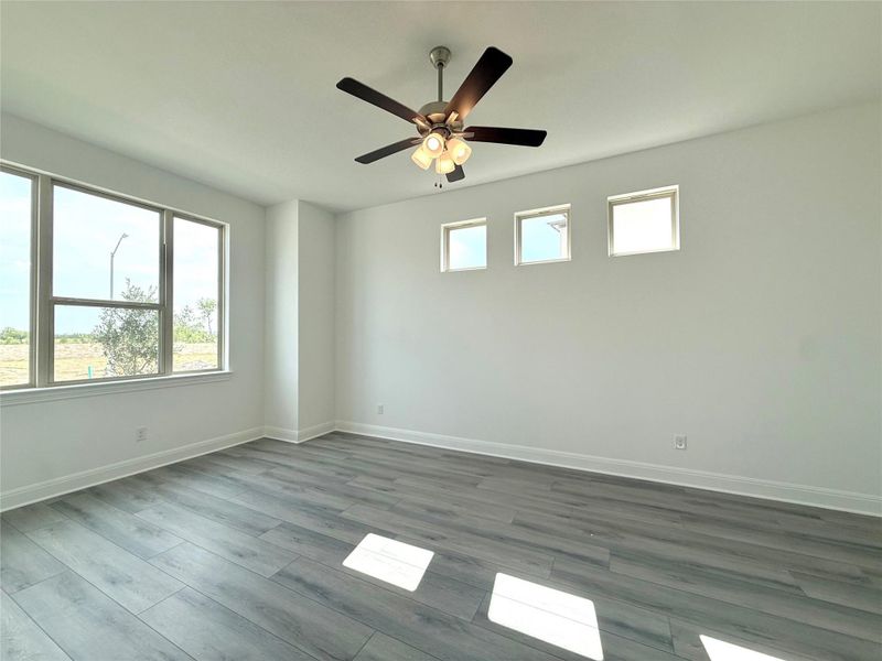 Empty room featuring wood finished floors and ceiling fan Empty room featuring wood finished floors and ceiling fan