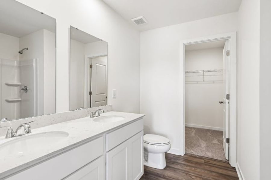 A bathroom with a toilet and sink.