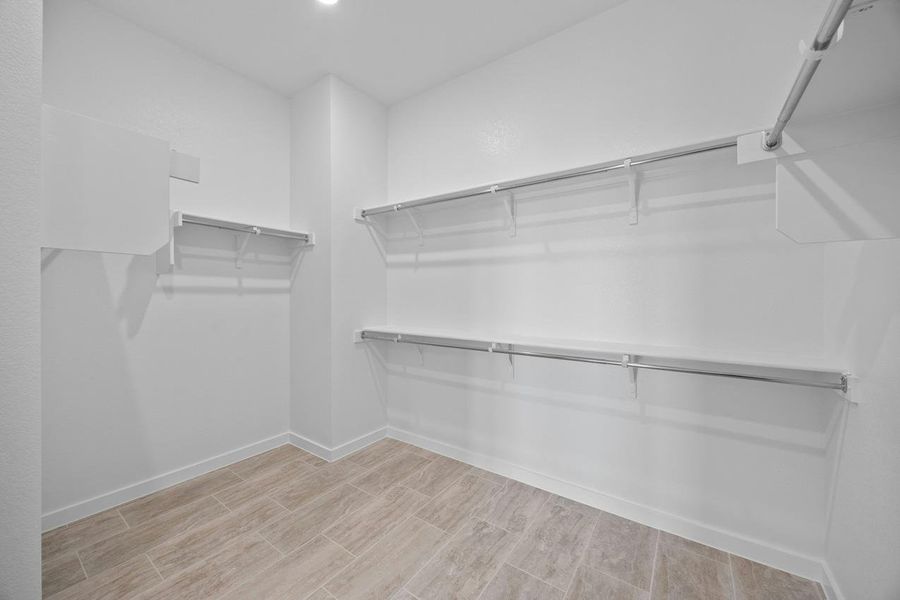Spacious closet featuring light wood finished floors Spacious closet featuring light wood finished floors