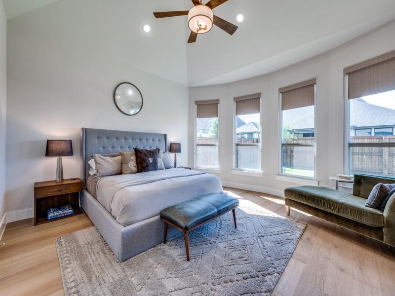 Bedroom with light wood-style flooring, baseboards, recessed lighting, lofted ceiling, and a ceiling fan