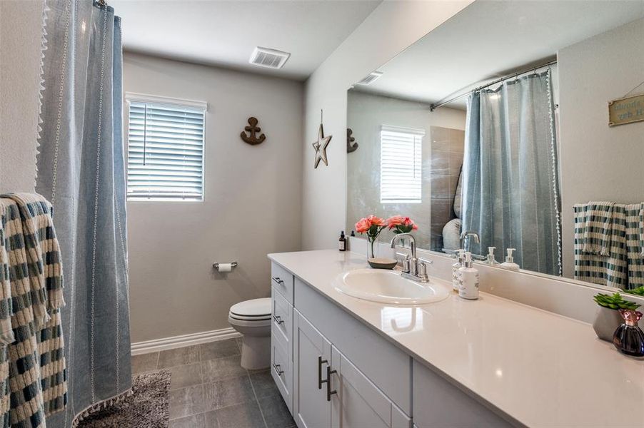 Bathroom with vanity and a shower with curtain