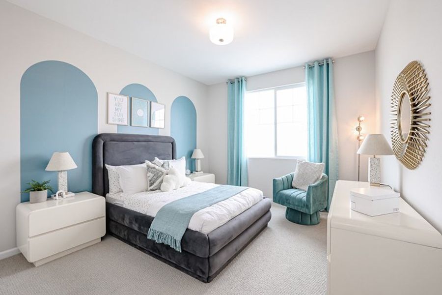 A bedroom with a bed and a chair. A bedroom with a bed and a chair.