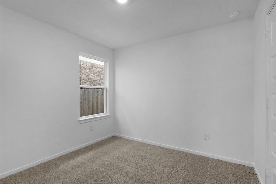 Empty room with baseboards and carpet