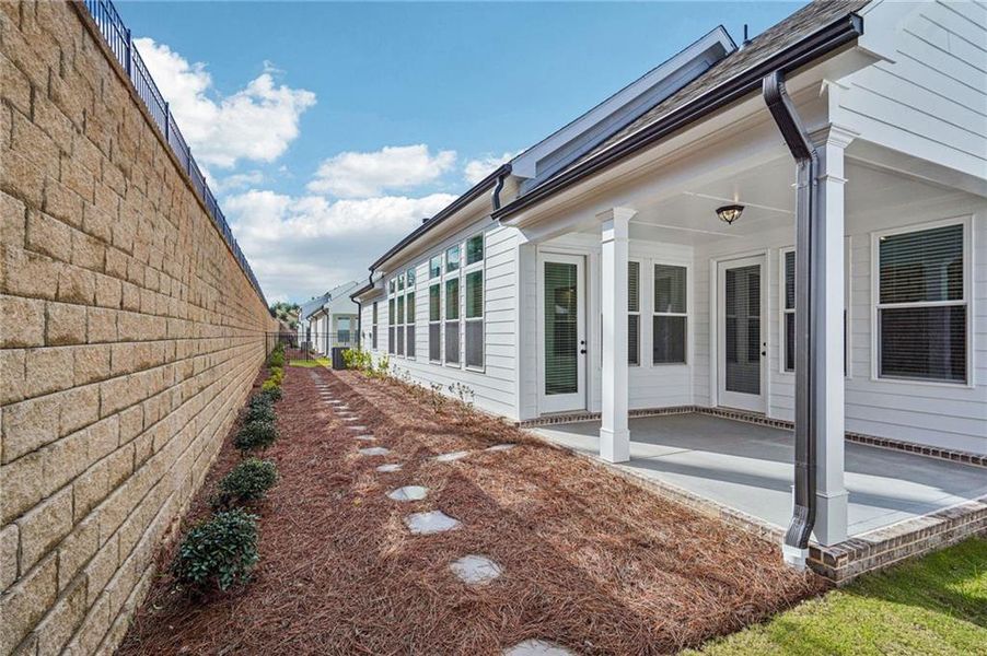 Exterior details and patio area of a home in Promenade at Sawnee Village, Cumming (Image 18).