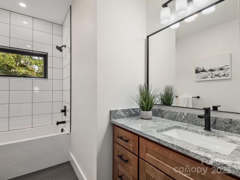 Full bathroom on main level with views to surrounding trees