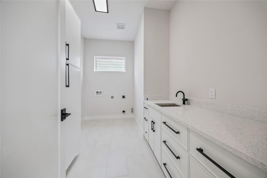 The second-floor utility room adds everyday convenience with built-in cabinetry, countertop workspace, and additional storage. Positioned near the bedrooms, the layout keeps daily functionality practical and efficient. The second-floor utility room adds everyday convenience with built-in cabinetry, countertop workspace, and additional storage. Positioned near the bedrooms, the layout keeps daily functionality practical and efficient.